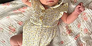 Esmé joined the competition — help win amazing prizes! adorable, baby, blanket, bonnet, child, clothing, cute, fabric, floral_pattern, foot, hand, indoor, infant, lying_down, newborn, person, portrait, romper, skin, soft_toys