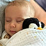 Ava is registered to the contest to win money with this photo: baby, sleeping, plush_toy, penguin, blanket, cozy, child, soft_toy, infant, cute, peaceful, nap, closeup, portrait, indoor, warm, resting, comfort, cuddling, toddler