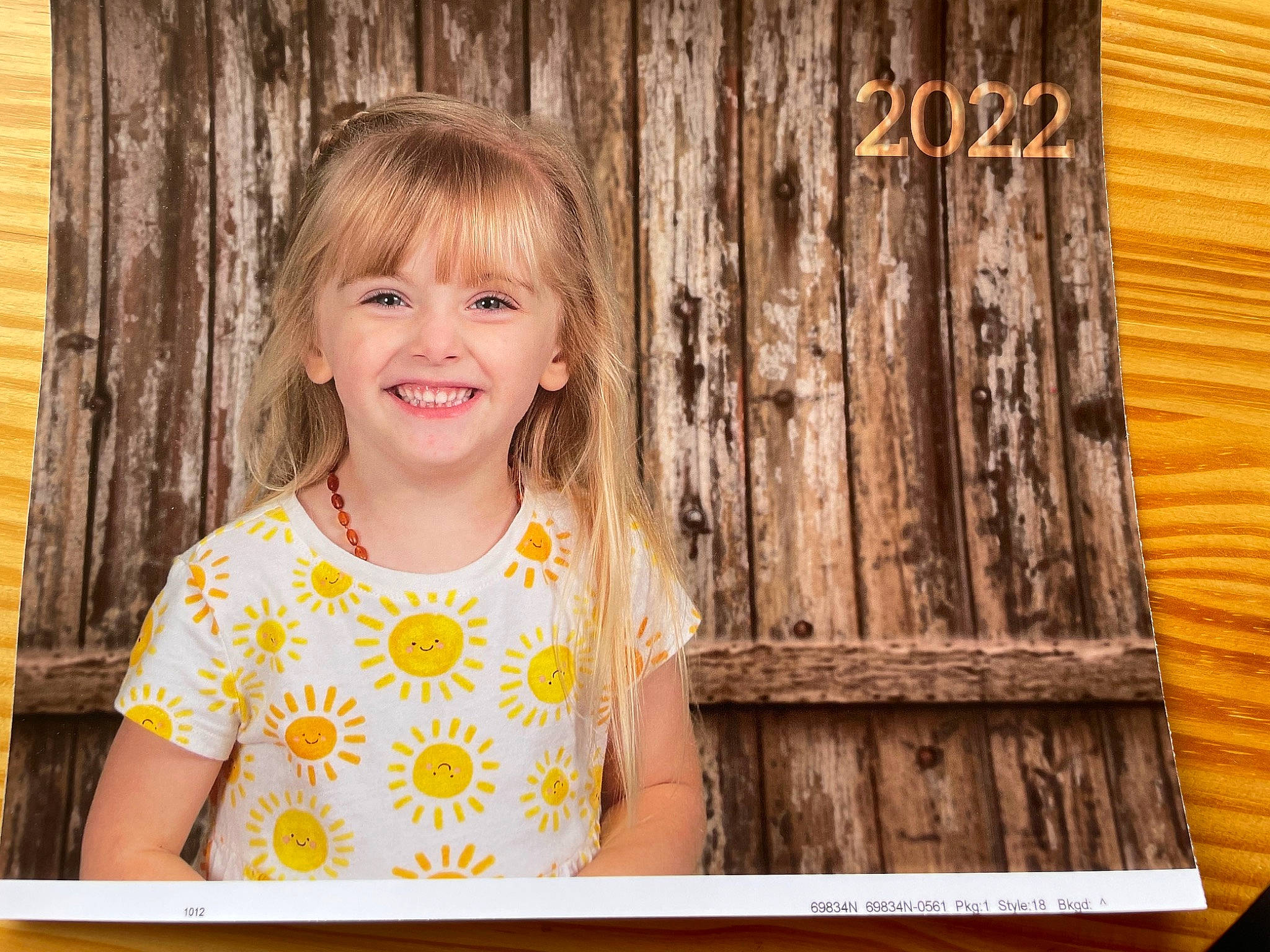 Kelsey is registered to the contest to win money with this photo: blond, brown_hair, cheek, child, flash_photography, fun, grass, hair, happy, hardwood, iris, joy, people_in_nature, person, rectangle, sitting, smile, t_shirt, toddler, tree