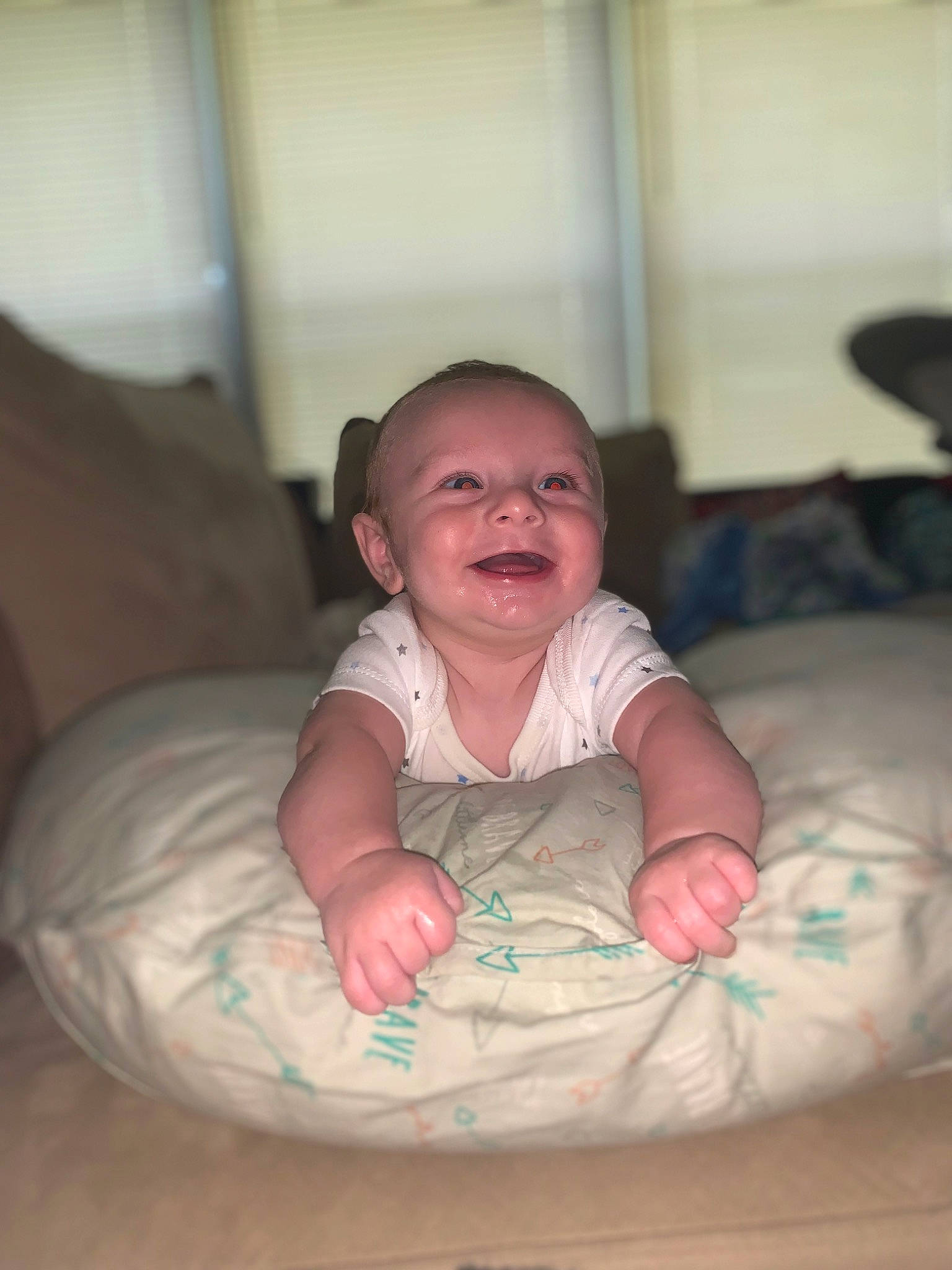 Kayden is registered to the contest to win money with this photo: baby, baby_toddler_clothing, bean_bag, cheek, child, comfort, flash_photography, flooring, fun, happy, hardwood, laugh, linens, mouth, person, room, sitting, skin, smile, toddler