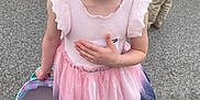 Kylie is registered to the contest to win money with this photo: child, girl, smiling, dress, pink, blue, basket, plastic_eggs, outdoor, asphalt, people, legs, feet, happy, cute, spring, event, celebration, easter, fashion