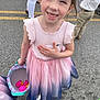 child, girl, smiling, dress, pink, blue, basket, plastic_eggs, outdoor, asphalt, people, legs, feet, happy, cute, spring, event, celebration, easter, fashion