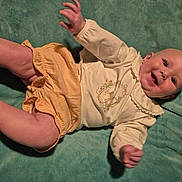 Journee joined the competition — help win amazing prizes! baby, infant, smiling, clothing, yellow_shorts, cream_top, deer_print, blanket, green_blanket, happy, cute, hands, legs, face, portrait, lying_down, child, indoors, soft_texture, toddler
