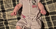 Journee joined the competition — help win amazing prizes! adorable, baby, barefoot, child, curious_expression, cute, face, headband, hello_kitty, indoors, infant, laying_down, person, plaid_blanket, romper, skin, small_feet, small_hands, soft_lighting, striped_clothing