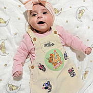 Zahra joined the competition — help win amazing prizes! baby, child, smiling, headband, pink, dress, minnie_mouse, blanket, stars, moon, cute, infant, lying_down, happy, clothing, soft_texture, adorable, portrait, toddler, playful