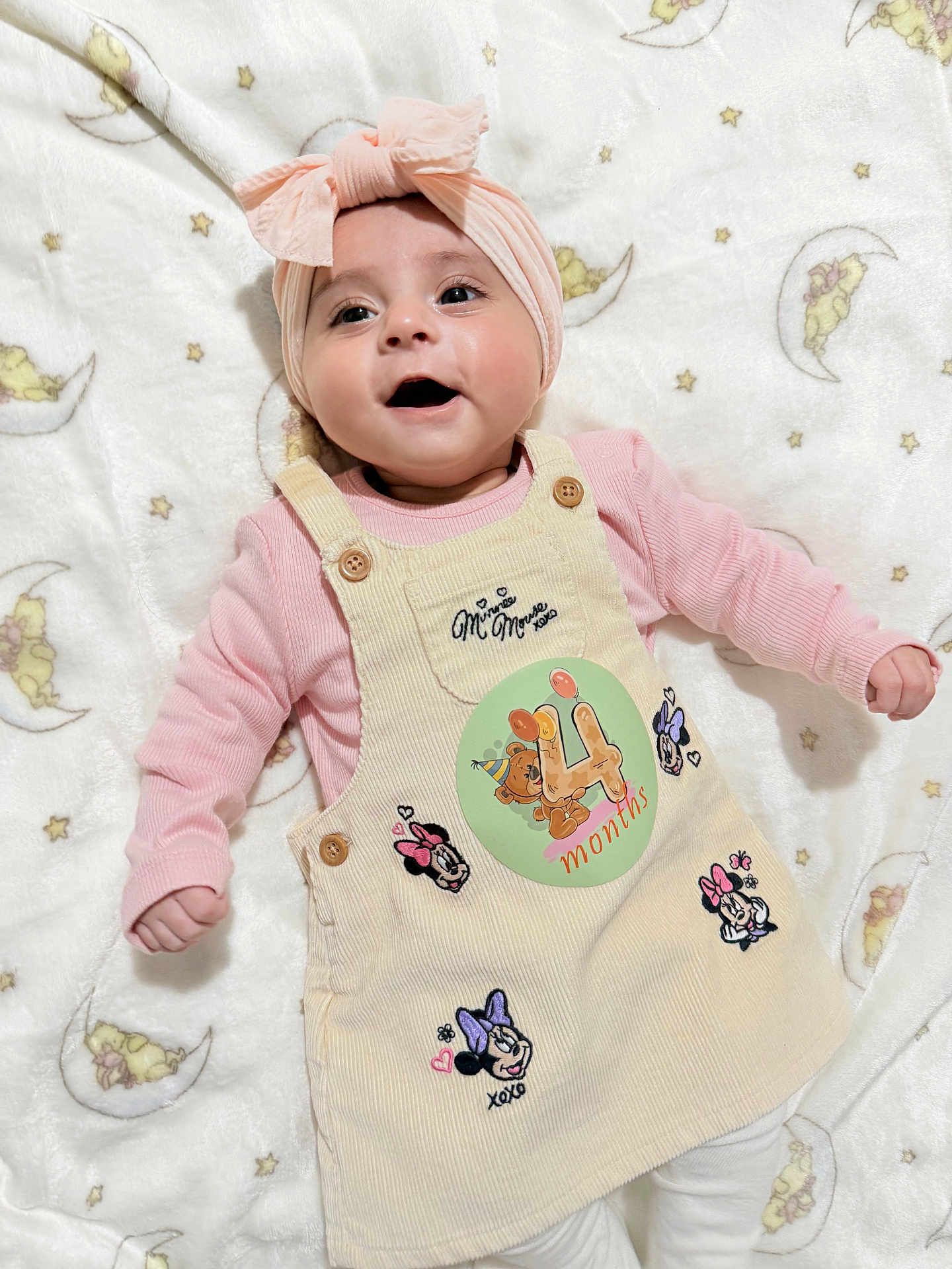 Zahra joined the competition — help win amazing prizes! baby, child, smiling, headband, pink, dress, minnie_mouse, blanket, stars, moon, cute, infant, lying_down, happy, clothing, soft_texture, adorable, portrait, toddler, playful