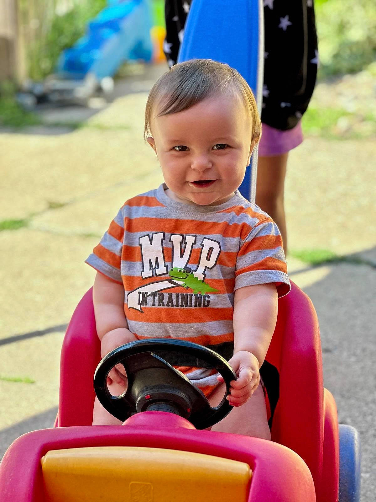 Jonah joined the competition — help win amazing prizes! baby, baby_playing_with_toys, baby_products, baby_toddler_clothing, child, eye, fun, happy, joy, leisure, mammal, person, pink, recreation, riding_toy, sitting, skin, smile, t_shirt, toddler