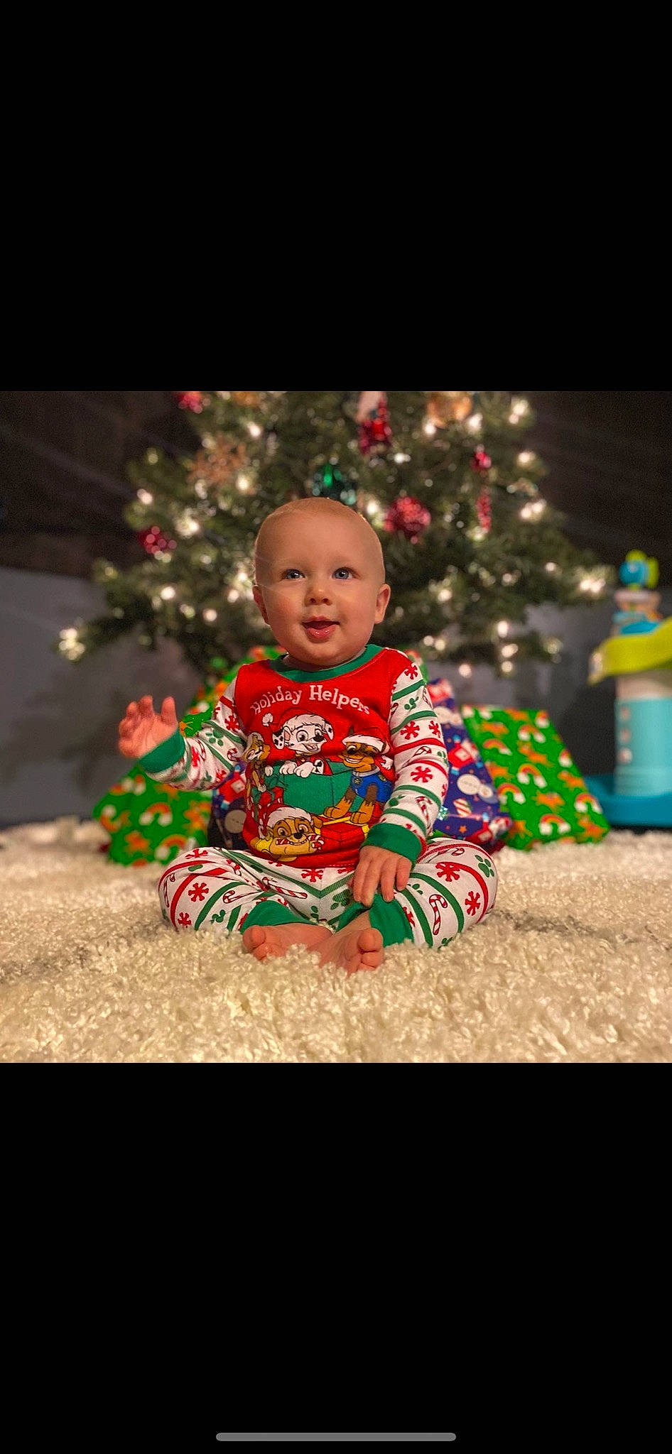 Russell is registered to the contest to win money with this photo: baby, baby_toddler_clothing, child, christmas, christmas_decoration, christmas_eve, christmas_ornament, christmas_tree, event, face, flash_photography, fun, happy, holiday, person, sitting, sleeve, smile, toddler, tradition