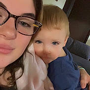 Malachi joined the competition — help win amazing prizes! woman, child, glasses, blanket, indoor, portrait, face, couch, home, person, childhood, cozy, family, casual, blue_shirt, skin, hair, photography, smile, closeup