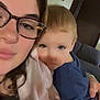 woman, child, glasses, blanket, indoor, portrait, face, couch, home, person, childhood, cozy, family, casual, blue_shirt, skin, hair, photography, smile, closeup