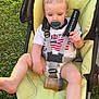Malachi joined the competition — help win amazing prizes! toddler, child, stroller, pacifier, bottle, grass, sidewalk, outdoor, clothing, baby, seatbelt, yellow_cushion, foot, hand, person, casual, daylight, relaxed, infant, summer
