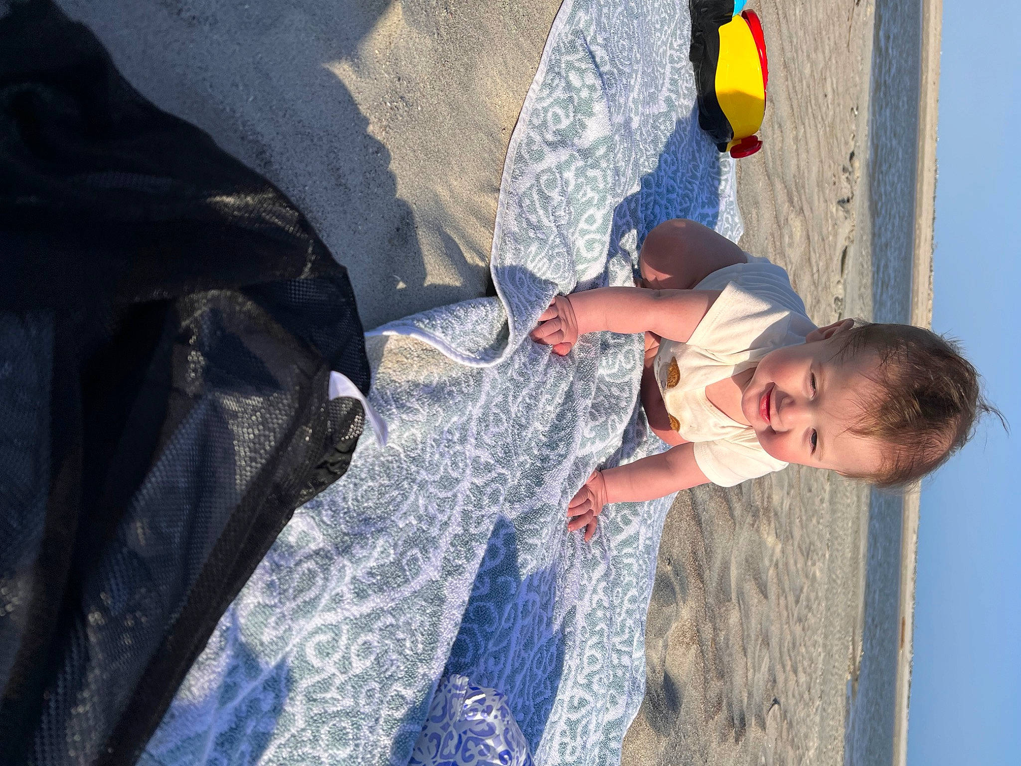 Alex is registered to the contest to win money with this photo: adventure, automotive_exterior, azure, beach, child, concrete, electric_blue, fun, landscape, leisure, person, play, recreation, rock, sand, shadow, sport_climbing, t_shirt, toddler, vacation