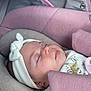 baby, sleeping, headband, bow, car_seat, pink, grey, soft_texture, clothing, infant, peaceful, cute, child, portrait, resting, closeup, indoors, comfort, newborn, face