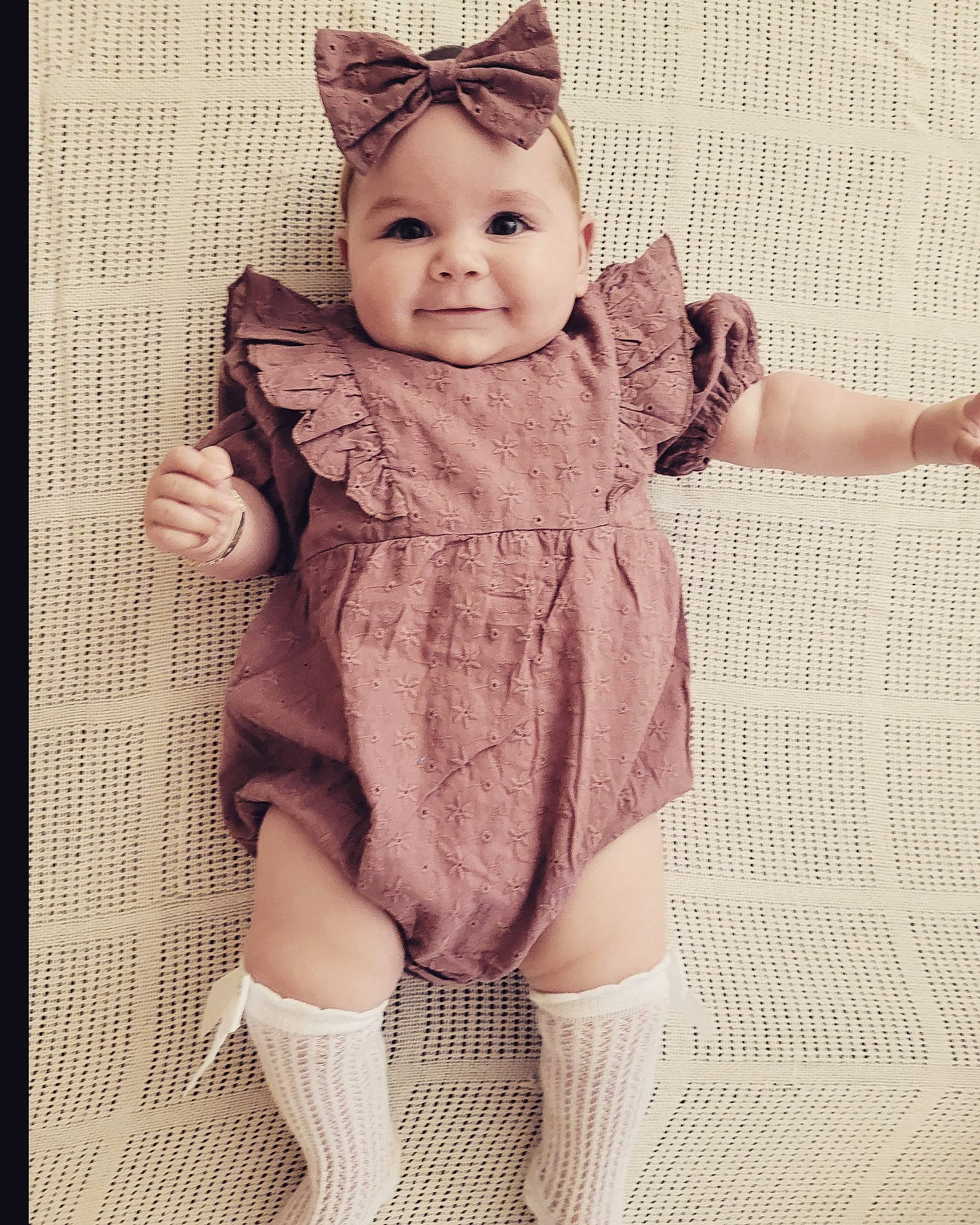 Honey is registered to the contest to win money with this photo: arm, baby, baby_toddler_clothing, eye, face, finger, hand, happy, head, headgear, human_body, knee, outerwear, person, pink, skin, sleeve, smile, thigh, thumb