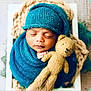 Jadon is registered to the contest to win money with this photo: baby, basket, blanket, blue, child, cozy, cute, infant, knit_hat, knitted, newborn, peaceful, portrait, sleep, sleeping, soft_lighting, teal, teddy_bear, toy, wrapped