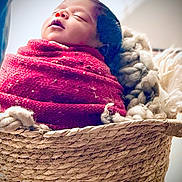 Jadon joined the competition — help win amazing prizes! baby, basket, blanket, child, cozy, cute, face, head, indoors, infant, newborn, peaceful, portrait, resting, sleeping, soft, texture, warm, woven, wrapped