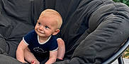 émile a rejoint le concours — aidez-le/la à gagner de superbes lots ! baby, child, blue_eyes, smiling, sitting, black_chair, outdoor, greenery, cushion, cute, infant, happy, person, portrait, blond_hair, casual_clothing, floor, daylight, nature, relaxing