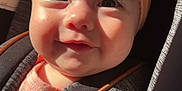 Brinley is registered to the contest to win money with this photo: baby, infant, headband, bow, car_seat, sunlight, close_up, face, cute, child, smile, straps, clothing, seatbelt, young_child, indoors, safety, skin, expression, portrait