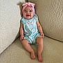 baby, child, smiling, headband, pink, romper, blue, butterfly, sitting, couch, beige, texture, happy, cute, infant, portrait, indoors, people, legs, feet
