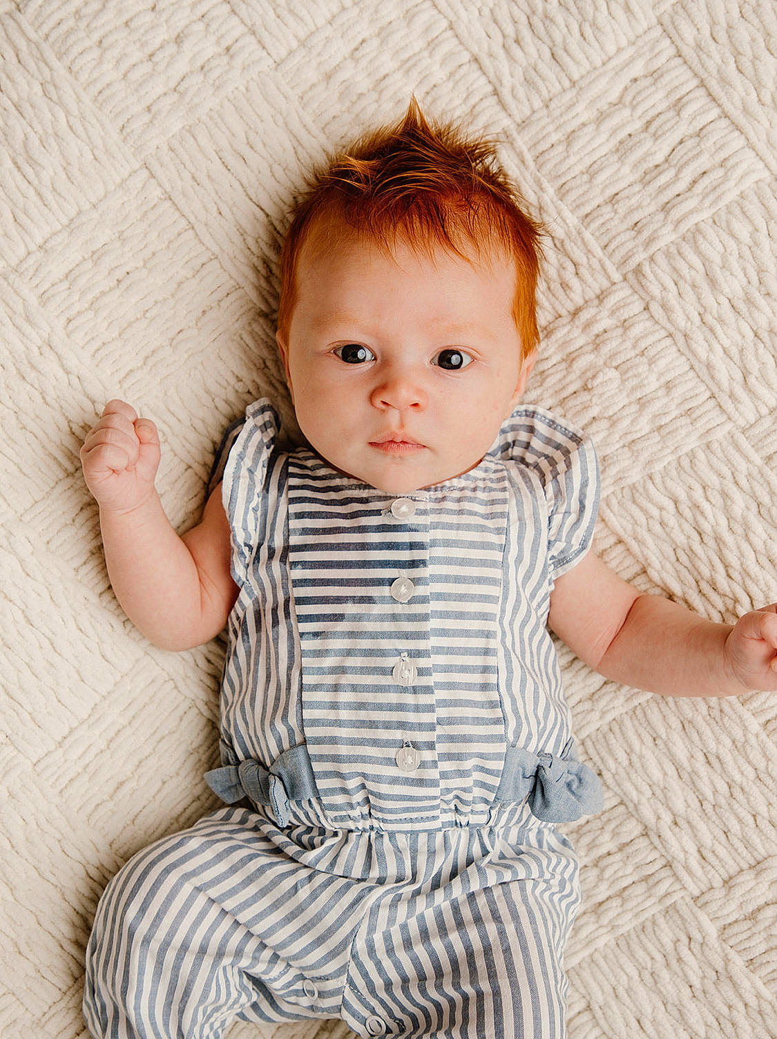 Bradie is registered to the contest to win money with this photo: arm, baby, baby_toddler_clothing, cheek, child, chin, collar, comfort, face, finger, flooring, happy, iris, lip, pattern, person, sitting, skin, sleeve, toddler