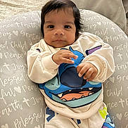 Ian Montiel joined the competition — help win amazing prizes! baby, infant, child, cute, face, clothing, sweatshirt, pants, cushion, text, pattern, indoor, portrait, looking, hands, soft, comfortable, young, smiling, cozy