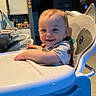 Titan joined the competition — help win amazing prizes! toddler, high_chair, smiling, child, indoor, kitchen, food_crumbs, face, person, seat, table, furniture, happy, baby, short_hair, casual_clothing, home, light, tray, raccoon_design