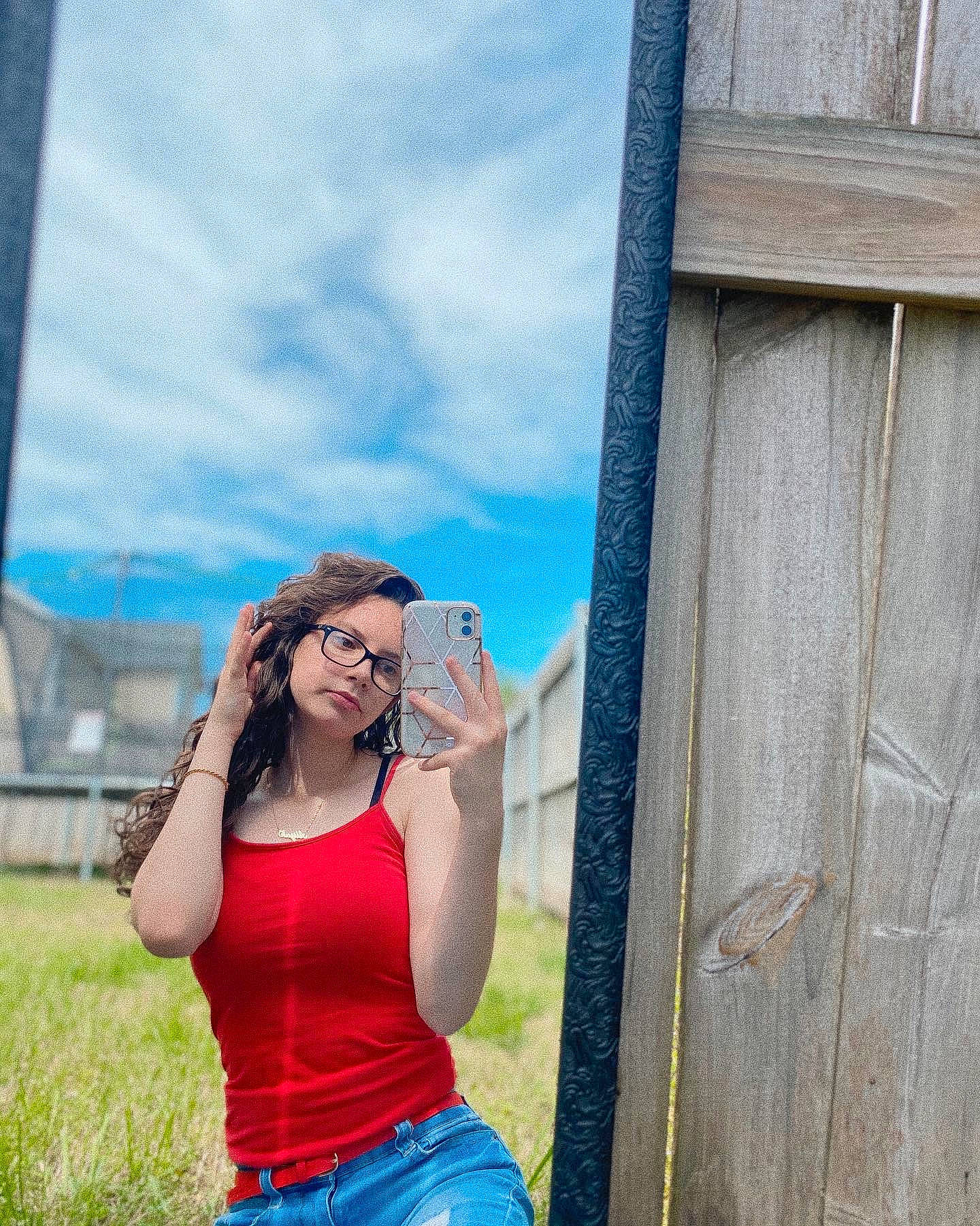 Haley is registered to the contest to win money with this photo: beauty, blue, eyewear, fun, glasses, grass, jeans, leisure, long_hair, person, photo_shoot, photograph, photography, red, smile, summer, sunglasses, tree, vacation, wall