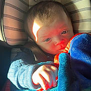 Logan joined the competition — help win amazing prizes! baby, infant, child, car_seat, blanket, plush_toy, sunlight, portrait, hand, seatbelt, buckle, stripes, blue_blanket, cozy, sleepy, closeup, car_interior, expression, soft_texture, fabric