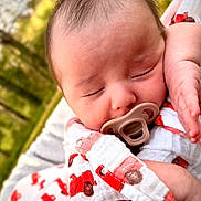 Zander joined the competition — help win amazing prizes! baby, infant, newborn, sleeping, pacifier, swaddle, blanket, car_pattern, close_up, portrait, face, hand, arm, cheek, hair, outdoors, trees, greenery, soft_light, peaceful