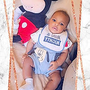Cameron joined the competition — help win amazing prizes! baby, child, mickey_mouse, plush_toy, bib, couch, marble_background, sparkle_border, sitting, clothing, smiling, cute, indoor, portrait, person, toy, infant, comfortable, decorative_frame, young_child