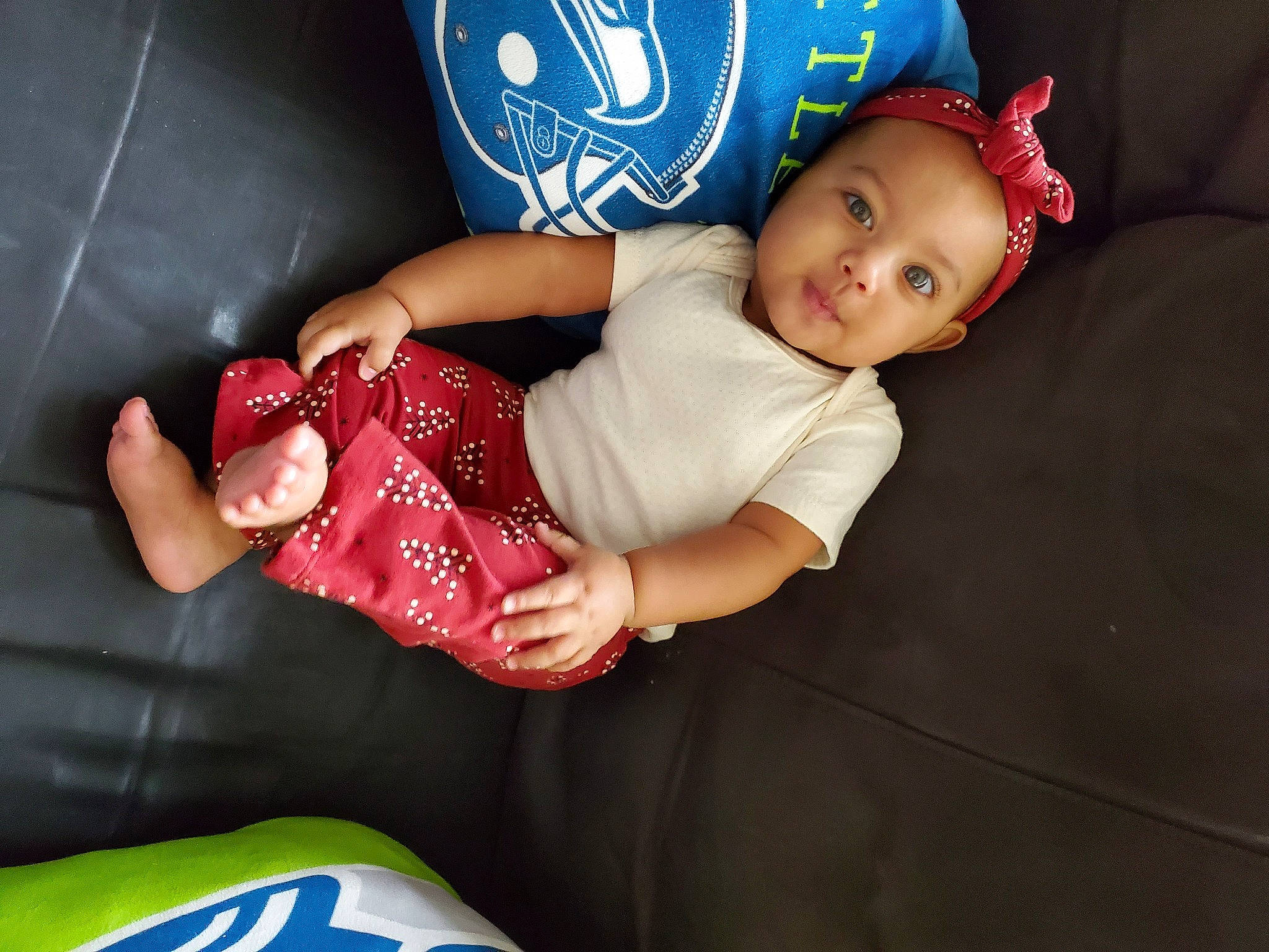 Ariah is registered to the contest to win money with this photo: arm, baby, baby_products, baby_toddler_clothing, child, comfort, couch, elbow, finger, flash_photography, fun, hand, happy, headwear, human_leg, lap, person, room, sitting, t_shirt