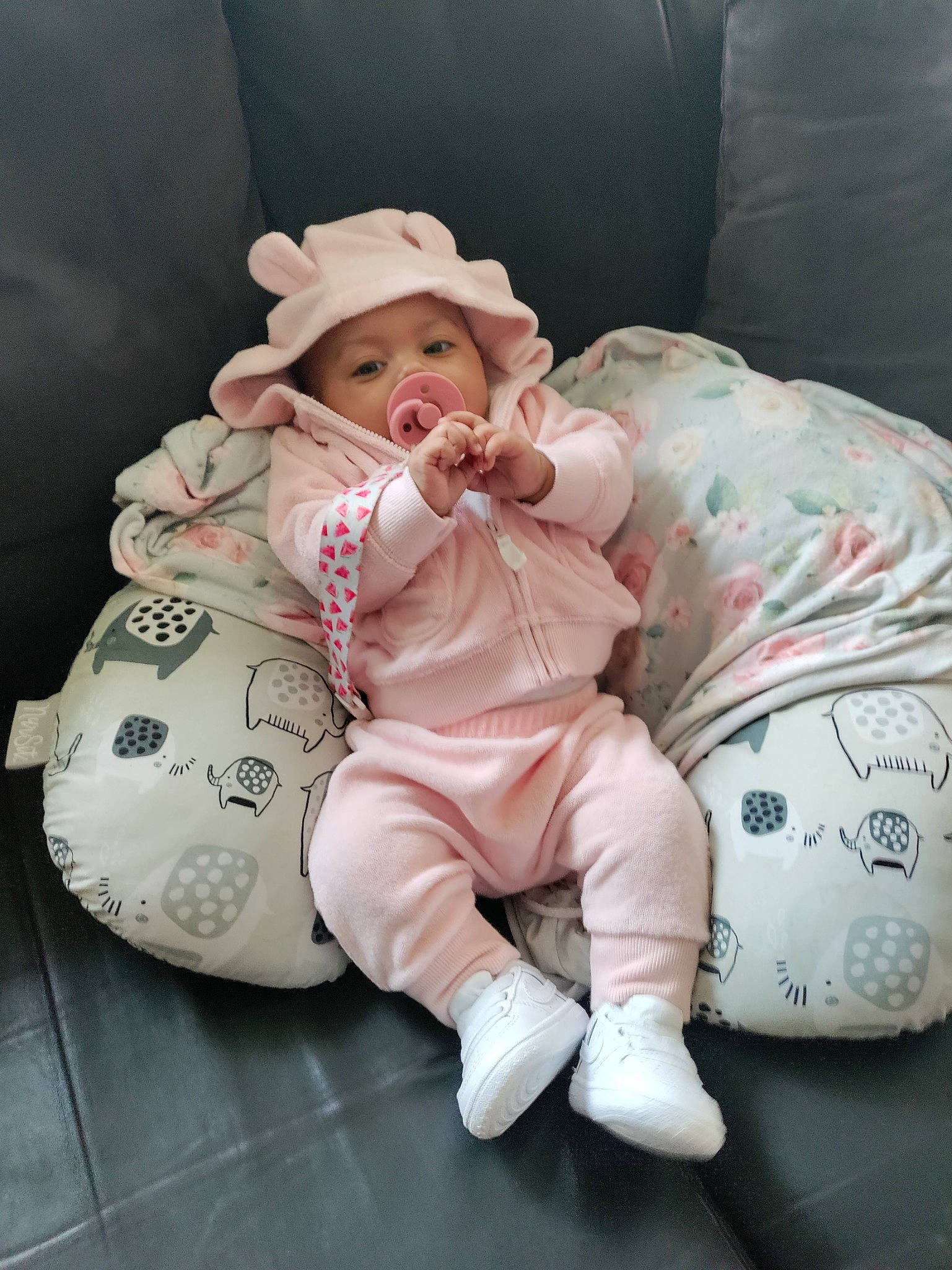 Ariah is registered to the contest to win money with this photo: baby, baby_products, baby_sleeping, baby_toddler_clothing, carmine, cheek, child, comfort, foot, happy, hat, head, headgear, headwear, linens, person, pink, sitting, sleeve, sun_hat