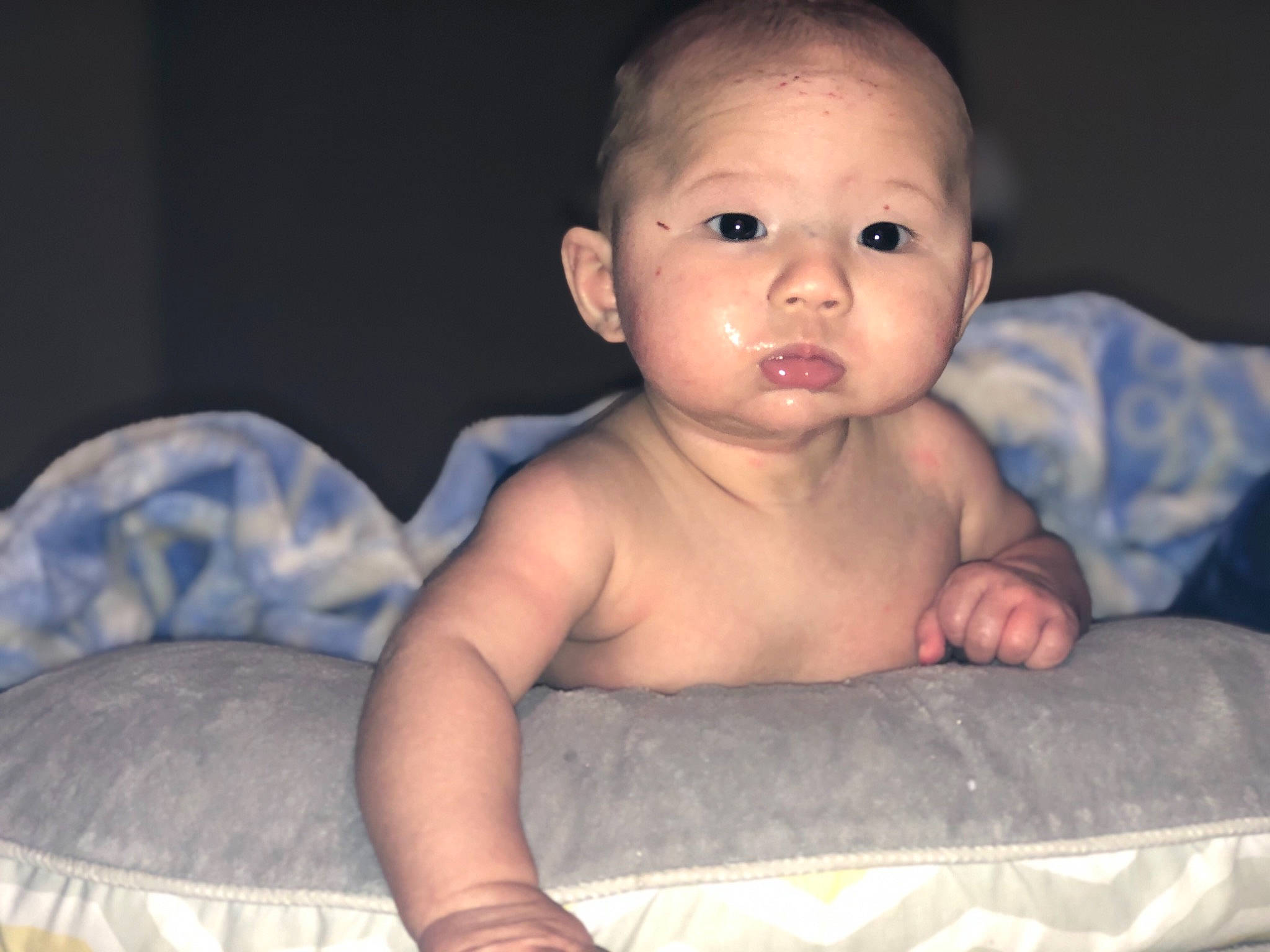 Bentley is registered to the contest to win money with this photo: arm, baby, cheek, child, chin, eye, face, finger, furniture, head, iris, lip, mouth, muscle, nose, person, sitting, skin, smile, toddler