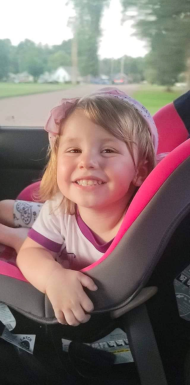 Bayleigh joined the competition — help win amazing prizes! automotive_design, eye, face, facial_expression, finger, grass, hairstyle, happy, head, joy, leisure, lip, motor_vehicle, person, pink, plant, skin, smile, steering_wheel, toddler