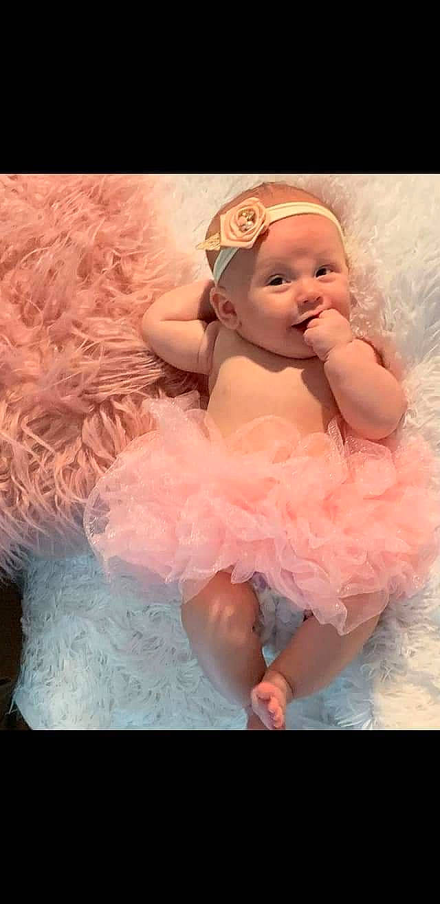 Bayleigh joined the competition — help win amazing prizes! baby, baby_toddler_clothing, bridal_accessory, child, day_dress, dress, embellishment, event, fashion_accessory, finger, flash_photography, fur, happy, headgear, headpiece, headwear, peach, person, petal, pink