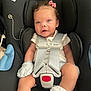 Luna joined the competition — help win amazing prizes! baby, car_seat, infant, child, seatbelt, pink_bow, mittens, white_clothing, socks, lace, safety, cute, adorable, face, head, eyes, mouth, skin, hair, indoor