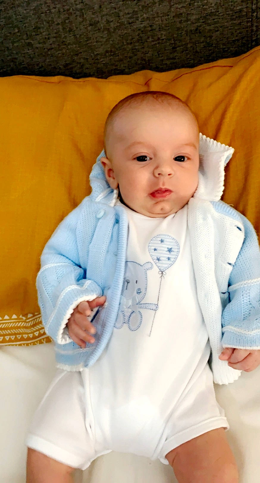 Archie Witts is registered to the contest to win money with this photo: baby, baby_products, baby_toddler_clothing, cheek, child, eye, head, outerwear, person, product, skin, toddler, yellow