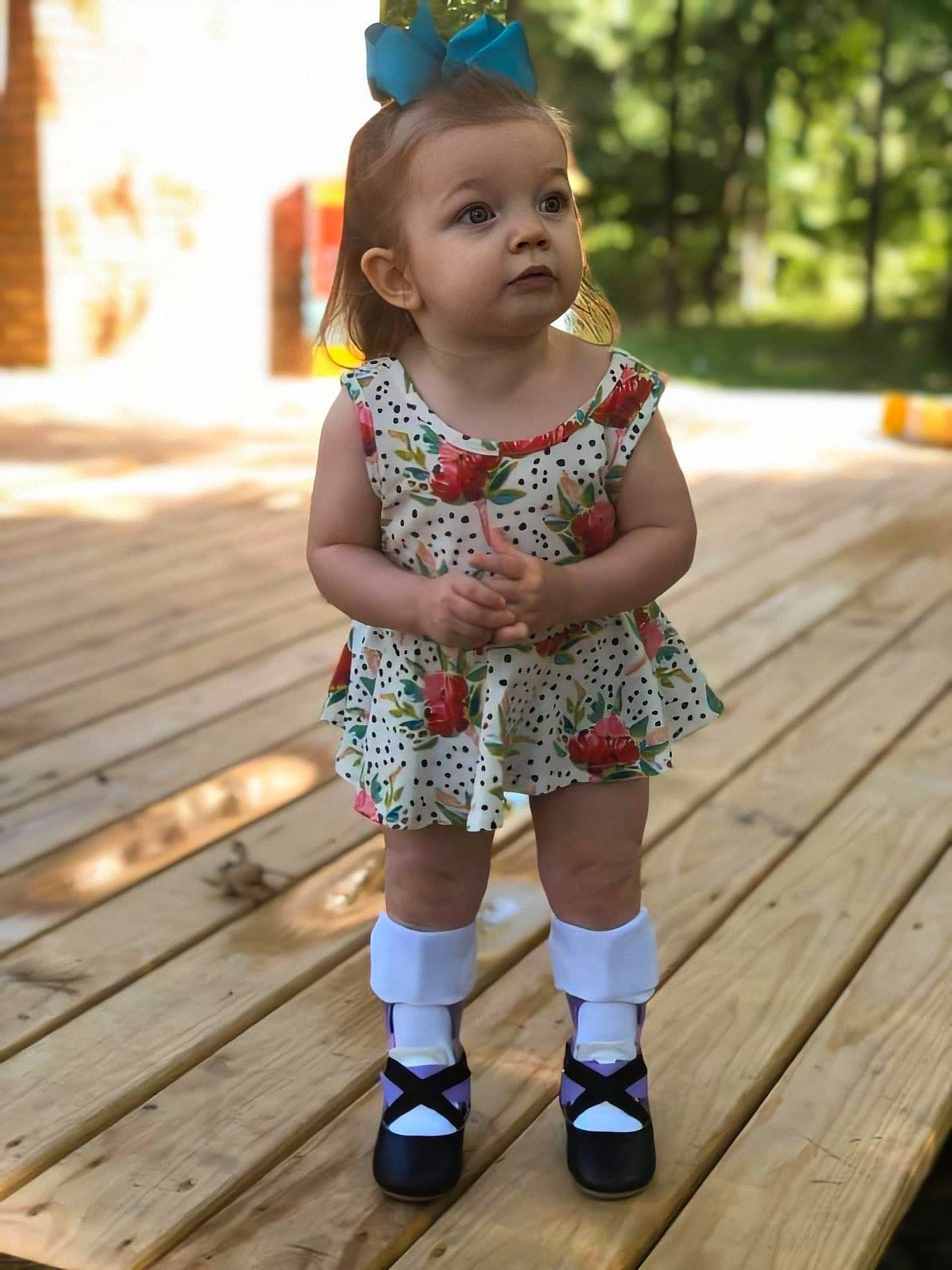 Annabel joined the competition — help win amazing prizes! baby, baby_toddler_clothing, child, child_model, dress, fashion_accessory, footwear, hair_accessory, happy, headband, headgear, pattern, person, play, shoe, skin, smile, toddler, wood, yellow