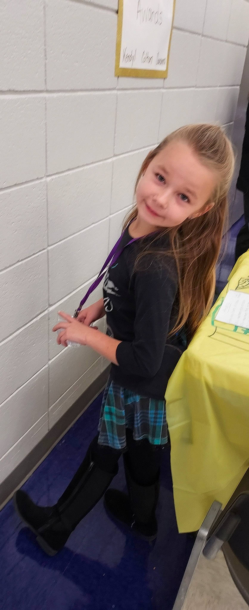 Kendyl is registered to the contest to win money with this photo: bag, blond, child, electric_blue, flooring, fun, human_leg, joy, knee, pattern, person, plaid, room, shorts, sleeve, smile, sportswear, t_shirt, tartan, thigh
