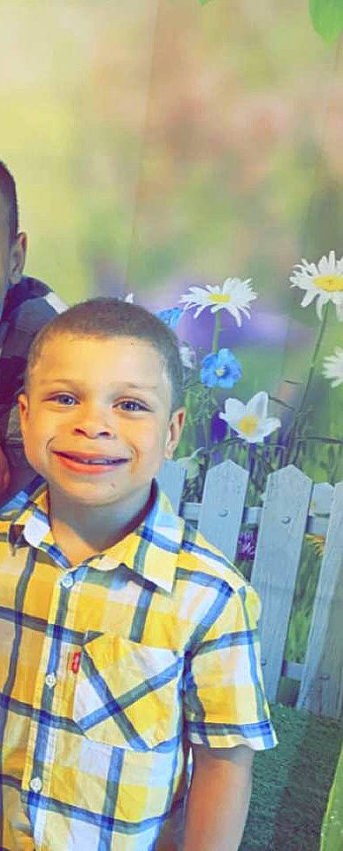 Legacy joined the competition — help win amazing prizes! annual_plant, child, electric_blue, fence, flower, flowering_plant, fun, grass, happy, iris, joy, laugh, leisure, people_in_nature, person, petal, plant, sitting, smile, spring