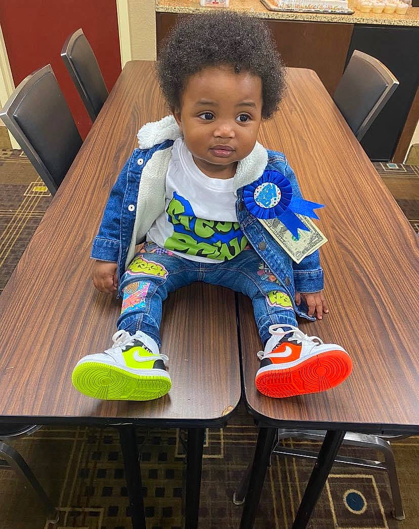 Maurice joined the competition — help win amazing prizes! baby, baby_products, baby_toddler_clothing, chair, child, comfort, couch, flooring, fun, furniture, hardwood, human_leg, leisure, person, play, sitting, sleeve, t_shirt, table, toddler