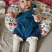 Emilia is registered to the contest to win money with this photo: baby, infant, child, denim_overalls, white_tights, pillow, animal_pattern, bottle, bed, blanket, cute, portrait, indoors, clothing, baby_bottle, resting, toddler, head, face, expression