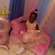Neveah joined the competition — help win amazing prizes! child, clothing, costume, couch, dress, face, female, footwear, formalwear, furniture, girl, hat, head, indoors, person, photography, portrait, shoe, sitting, toy
