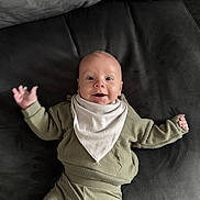 Chester joined the competition — help win amazing prizes! baby, infant, smiling, face, clothing, bib, couch, pillow, fabric, happy, person, indoor, cute, child, sitting, expression, portrait, soft, texture, relaxation