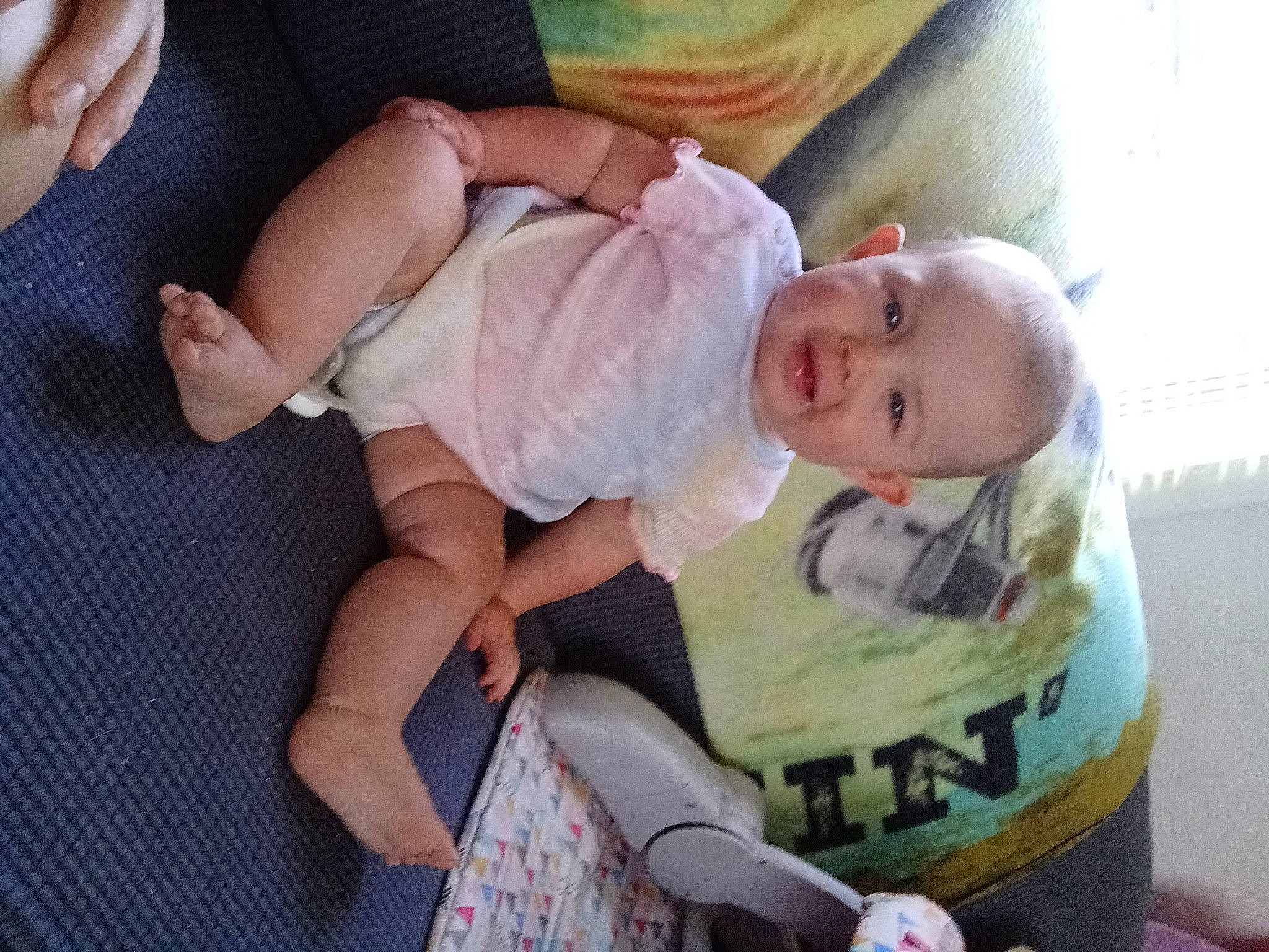 Serenity is registered to the contest to win money with this photo: baby, baby_products, baby_safety, baby_toddler_clothing, cheek, child, comfort, human_leg, knee, lap, nail, pattern, person, product, sitting, skin, smile, sock, thigh, thumb
