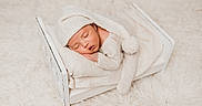 Louis joined the competition — help win amazing prizes! newborn, baby, sleeping, knitted_hat, pom_pom, white_bed, blanket, soft_texture, cozy, infant, peaceful, cute, portrait, indoors, warm_colors, fluffy_carpet, child, resting, small_bed, toddler