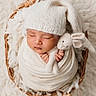 Louis is registered to the contest to win money with this photo: baby, newborn, infant, sleeping, knit_hat, knitted_toy, bunny, basket, wrap, swaddle, cozy, soft_texture, cream_color, cute, peaceful, portrait, indoor, child, adorable, blanket