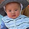baby, child, hat, wide_brimmed_hat, animal_print, bib, striped_bib, blue_clothing, face, headwear, outdoor, person, cute, chubby_cheeks, portrait, infant, young_child, soft_light, curious_expression, closeup