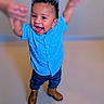 toddler, child, smiling, happy, blue_shirt, jeans, boots, standing, indoor, hands, playing, cute, portrait, person, hair, fashion, joy, fun, expression, young_kid