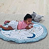 Ricky joined the competition — help win amazing prizes! baby, child, diaper, pink_shirt, play_mat, smiling, toy, plush_elephant, floor, wooden_floor, indoor, cute, lying_down, happy, infant, person, toddler, carpet, home, playtime